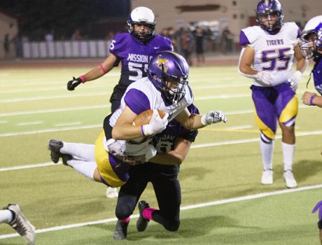 Powerful Tigers roll over Mission Oak Hawks in WYL football as LHS rolls into Dinuba Friday night Lemoore's Izzy Ramos stretching it out for a first down against Mission Oak Friday night in Tulare.